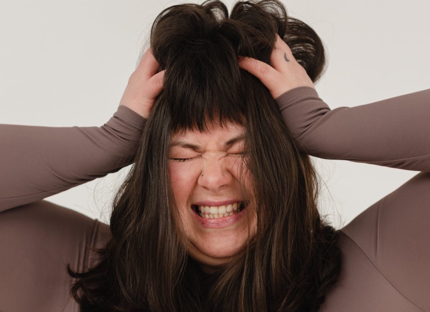 Distressed woman pulling hair out